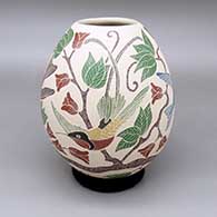 Polychrome jar with a sgraffito and painted bird-of-paradise, flower, leaf, and branch design
 by Guadalupe Melendez of Mata Ortiz and Casas Grandes