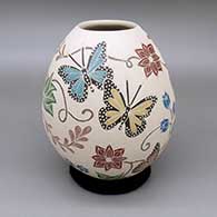 Polychrome jar with a sgraffito-and-painted butterfly, flower, branch, and leaf design
 by Guadalupe Melendez of Mata Ortiz and Casas Grandes