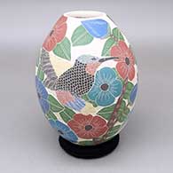 Polychrome jar with a  textured opening and a sgraffito and painted hummingbird, butterfly, flower, leaf, and branch design
 by Blanca Arras of Mata Ortiz and Casas Grandes