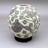 Polychrome jar with a sgraffito and painted cardinal, leaf, and tree branch design
 by Adrian Corona of Mata Ortiz and Casas Grandes