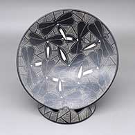 Black-on-white plate with a sgraffito dragonfly and fine line geometric design and a matching stand
 by Alex Ortega of Mata Ortiz and Casas Grandes