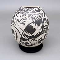 Black-on-white jar with a bold sgraffito bird, hummingbird, flower, and geometric design
 by Abraham Rodriguez of Mata Ortiz and Casas Grandes