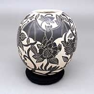 Black-on-white jar with a sgraffito bat and flower design
 by Diana Loya of Mata Ortiz and Casas Grandes