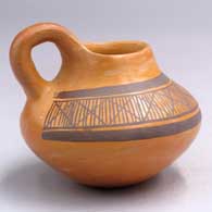 Black-on-yellow pitcher with a handle and a geometric design
 by Priscilla Namingha of Hopi