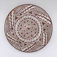 Polychrome shallow bowl with a geometric design on inside and fire clouds on outside
 by Helen Naha of Hopi