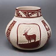A red-on-buff jar decorated with a sgraffito and carved three-panel stag and geometric design
 by Thomas Polacca of Hopi