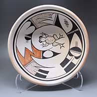 A polychrome bowl with fire clouds and decorated inside with a frog, bird element and geometric design
 by Fawn Navasie of Hopi