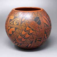 A black-on-red jar decorated with a four-panel shard and geometric design
 by Rondina Huma of Hopi