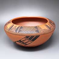 A black-on-red bowl with fire clouds and a two-panel bird element and geometric design below the shoulder and a four-panel crosshatching and geometric design above the shoulder
 by Rondina Huma of Hopi