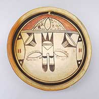 A shallow polychrome bowl with fire clouds and a bird element and geometric design inside
 by Unknown of Hopi