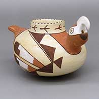 Polychrome parrot effigy jar with a painted bird print, feather, and geometric design; piece was produced using coal-firing
 by Bobby Silas of Hopi