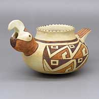 Polychrome parrot effigy jar with a painted geometric design; piece was produced using coal-firing
 by Bobby Silas of Hopi