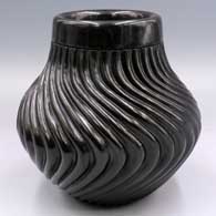 Black jar with a raised rim and 36 carved melon ribs
 by Gabriel Gonzales of Jemez