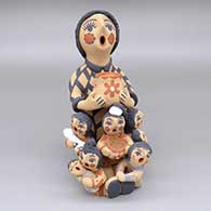 Polychrome storyteller with seven children, a bowl, a jar, and a bird
 by Bonnie Fragua of Jemez
