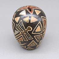 Small black and metallic polychrome jar with a geometric cut opening and a sgraffito and painted dragonfly and geometric design
 by Glendora Fragua of Jemez