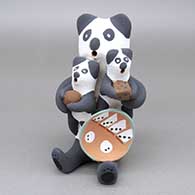 Polychrome panda bear storyteller with two cubs, a ball, a die, and a plate
 by Felicia Fragua of Jemez
