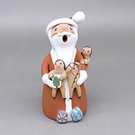 Polychrome Santa Claus storyteller with three children and wrapped presents
 by Diane Lucero of Jemez