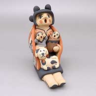 Polychrome storyteller wearing a manta with two children and a puppy
 by Chrislyn Fragua of Jemez