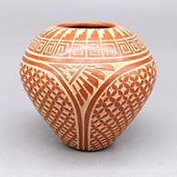 Small red jar with a sgraffito kiva step, feather, and geometric design; piece was made during the artist’s demonstration on December 27th, 2023 at Andrea Fisher Fine Pottery
 by Wilma Baca Tosa of Jemez