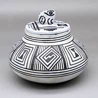 A black-on-pearl-gray jar with an eight-panel geometric design and a frog-handled lid with a geometric design
 by Joshua Madalena of Jemez