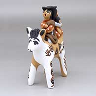 An Indian paint horse carrying a cowboy, cowgirl and baby
 by Felicia Fragua of Jemez