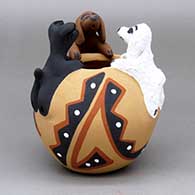 A polychrome friendship bowl with a geometric design and three puppies on the rim
 by Felicia Fragua of Jemez