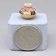 Miniature polychrome Sikyatki revival style jar with fire clouds and a geometric design
 by Thomas Natseway of Laguna