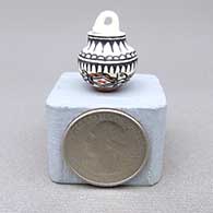 Miniature polychrome lidded jar with a geometric design and a lid with a handle
 by Thomas Natseway of Laguna