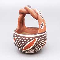Small polychrome basket with a braided handle and a geometric design
 by Unknown of Isleta