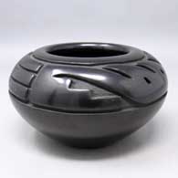 Black jar carved with a stylized avanyu design
 by Toni Roller of Santa Clara