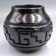 Black jar with a raised rim and a band of carved geometric design
 by Luann Tafoya of Santa Clara
