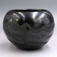Black-on-black jar decorated with an avanyu design
 by Mary Cain of Santa Clara