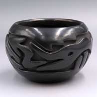 Black jar carved with a stylized avanyu and geometric design
 by Teresita Naranjo of Santa Clara