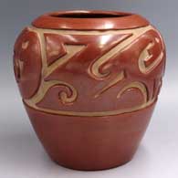 Red jar carved with a stylized avanyu design carved around the shoulder
 by Margaret Tafoya of Santa Clara