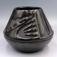 Black jar carved with a 4-panel feather and geometric design above the shoulder
 by Mary Singer of Santa Clara