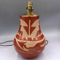 Red jar carved with an avanyu and geometric design, drilled and mounted with lamp hardware
 by Christina Naranjo of Santa Clara
