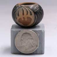 Miniature black jar with a sienna rim and spots plus a sgraffito bear paw medallion with a rose and geometric designF33
 by Kevin Naranjo of Santa Clara