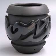 Black-on-black jar carved with an avanyu and geometric design
 by Shirley Tafoya of Santa Clara