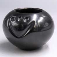 Small black jar carved with a bear paw imprint
 by Shirley Tafoya of Santa Clara