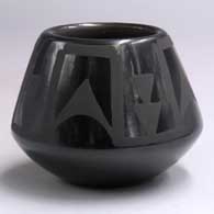 Black-on-black jar with a 4-panel geometric design
 by Pauline Martinez of San Ildefonso