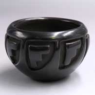 Black bowl carved with an 8-panel geometric design
 by Teresita Naranjo of Santa Clara