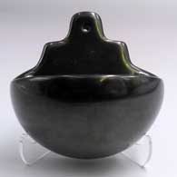 Polished black wall plaque with a bowl
 by Nathan Youngblood of Santa Clara