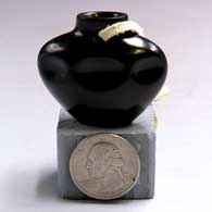 Miniature black jar with 3 indentations on one side and a carved bear paw imprint on the otherH08
 by Shirley Tafoya of Santa Clara