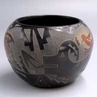 Black jar with sienna spots and a sgraffito avanyu, butterfly, hummingbird and geometric design
 by Candelaria Suazo of Santa Clara