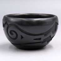 Small black bowl carved with an avanyu and geometric design and polished inside
 by Sherry Tafoya of Santa Clara