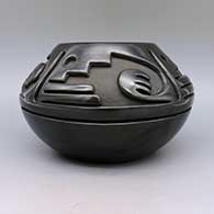 Black bowl carved with a geometric design, click or tap to see a larger version
