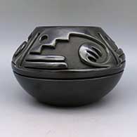 Black bowl carved with a geometric design, click or tap to see a larger version