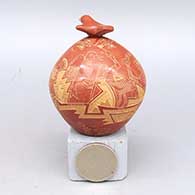 Miniature red lidded jar with sgraffito people, pueblo, Mimbres bird, and geometric design, with matching bird lid, click or tap to see a larger version