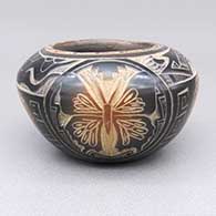 Small black bowl with a sienna rim and spots and a sgraffito butterfly, avanyu, flower, heart, bear paw, feather, and geometric design
 by Kevin Naranjo of Santa Clara