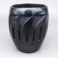 Black cylinder with a carved feather ring design
 by Camilio Tafoya of Santa Clara